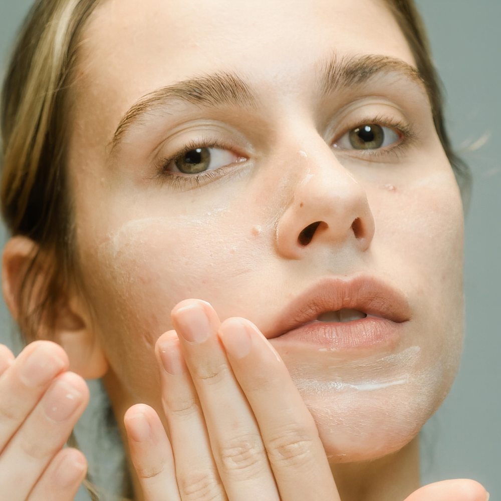 Femmes qui applique une crème sur sa peau sensible